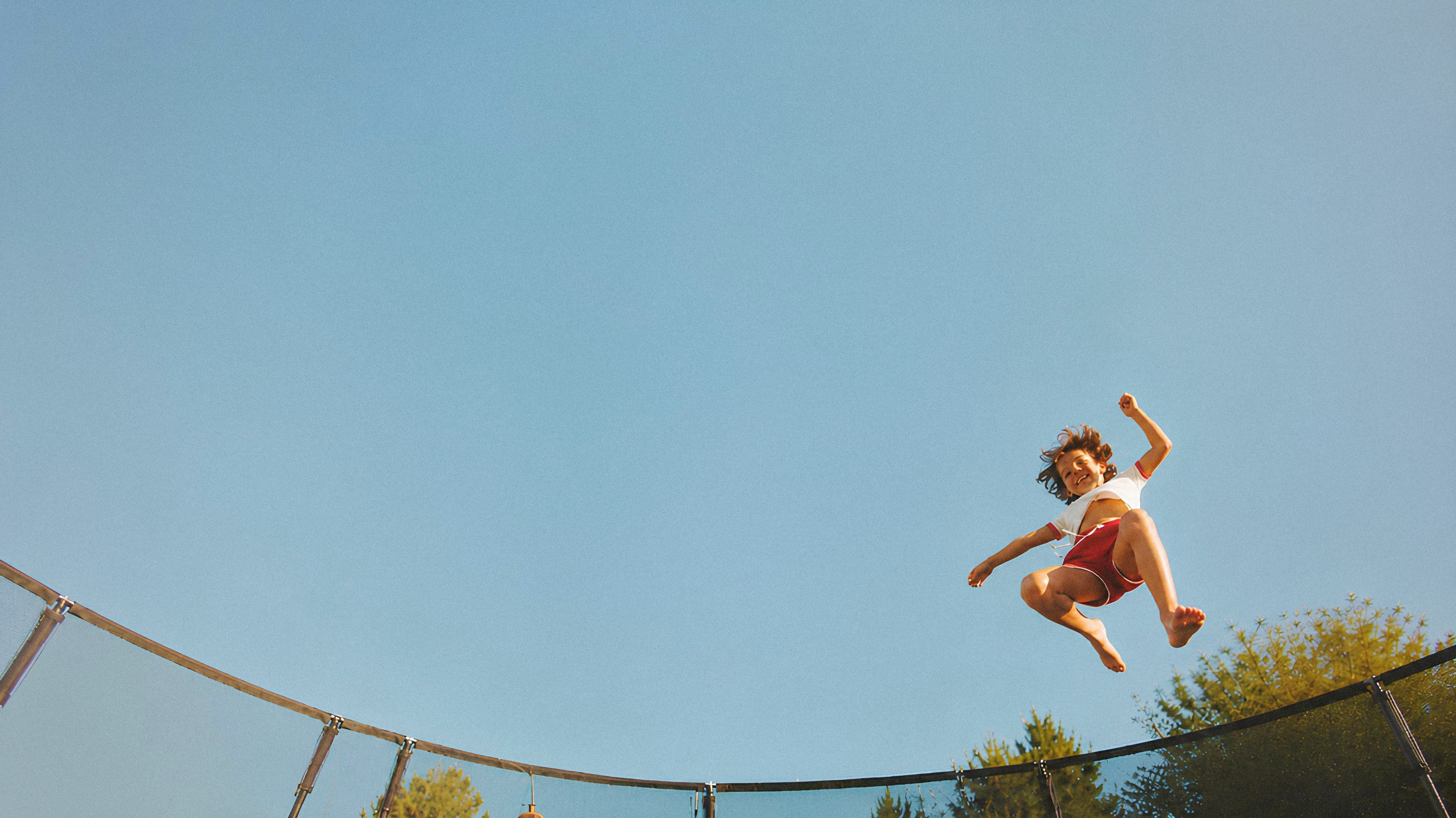 Child jumping on a professionally assembled trampoline in an Auckland backyard